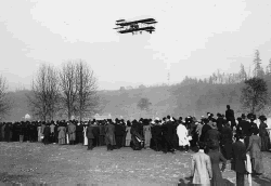 March 11, 1910, the first airplane flight in Seattle, at The Meadows. Aircraft is a Curtiss Reims Racer. Pilot is Charles K. Hamilton.