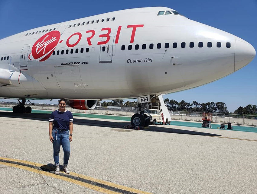 Unadkat standing in front of a plane