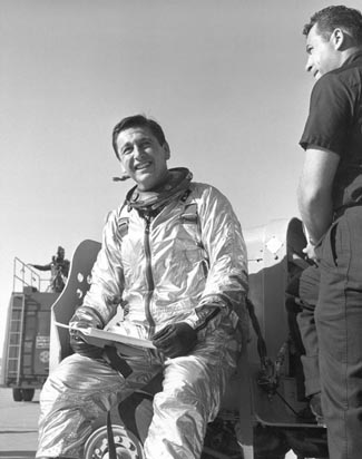 a black-and-white photo of Scott Crossfield in space suite