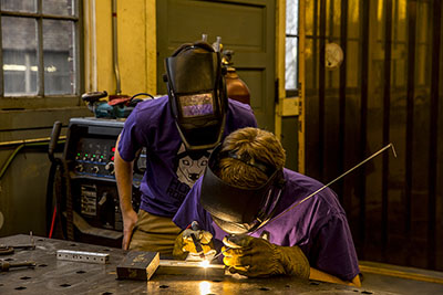 Two students welding