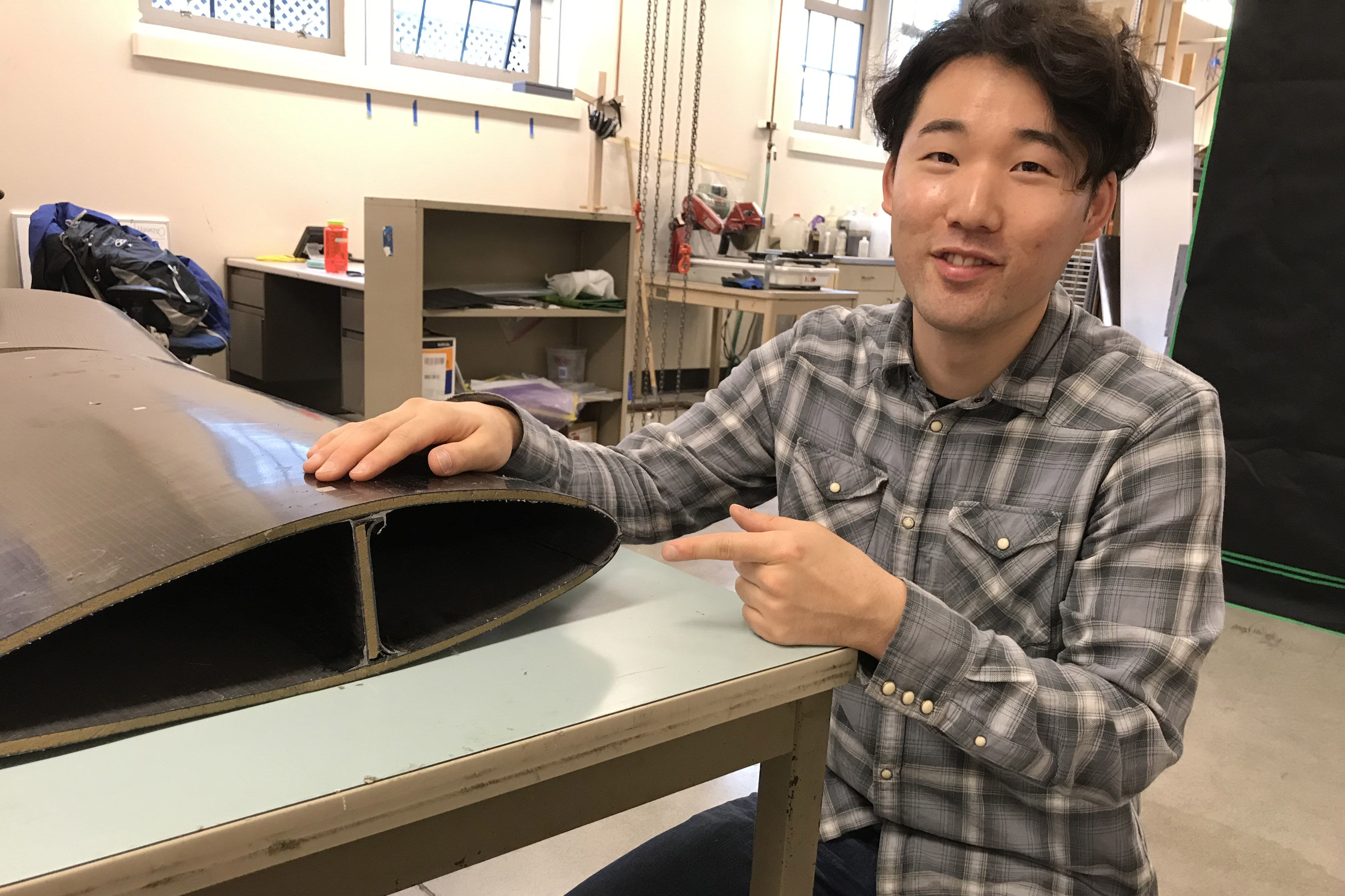 Man next to a prototype in a lab