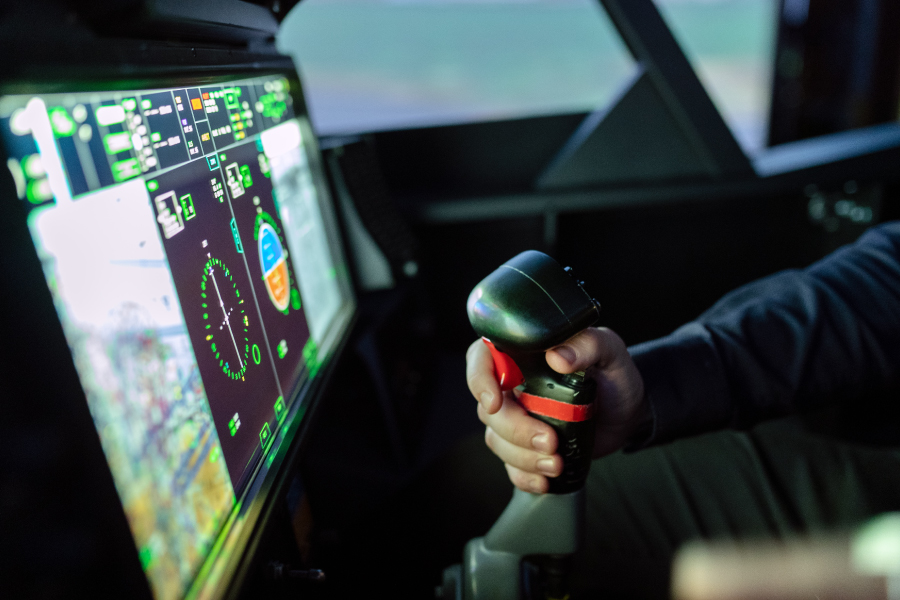 Close up of hand holding a control stick in a flight simulator