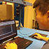 icon of student looking at computer linking to larger image