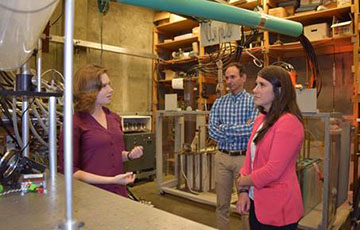 Rachel Peterson observing plasma sciences equipment