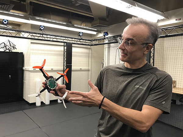 Behçet holding a small robot