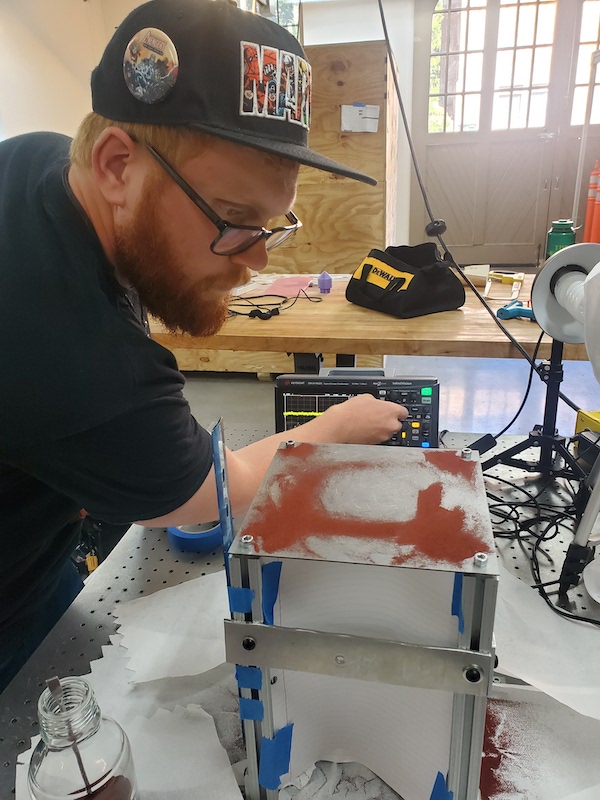 Male student preparing a vibrating plate in a lab