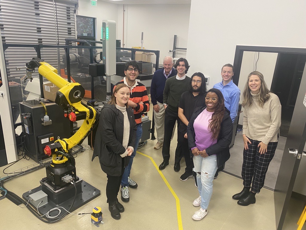 Group smiling to the camera during a facilities tour