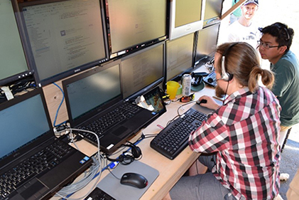 students working inside the Mobile Flight Operations Center to control drones in real-time during a flight test