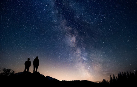 two people against a starry night sky