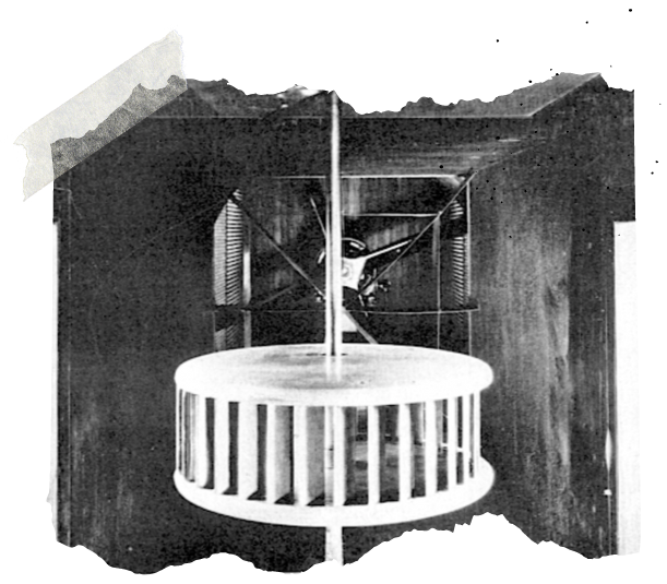 A vintage photograph of a propeller model in a wind tunnel, featuring a circular cage structure
