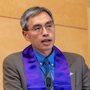 Gary Lai speaking at a podium