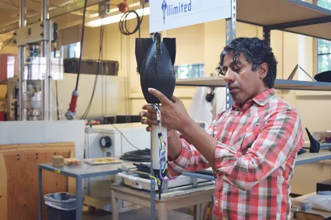 A person examines a protoype in a workshop.