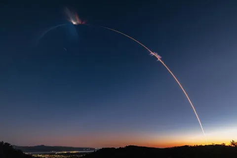 streak of light made by a rocket in a twilight sky
