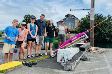 A family on a dock with a pink seaglider