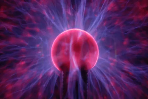 Plasma globe with colorful electric arcs emanating from a central sphere.